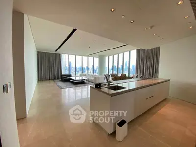 Luxurious open-plan living room with stunning city views and modern kitchen design.