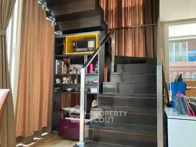 Modern interior with stylish staircase and built-in shelving, perfect for urban living.