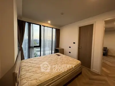 Cozy bedroom with large window and modern decor in a stylish apartment