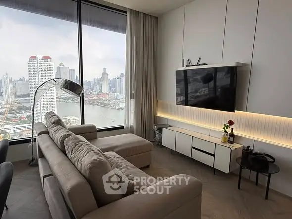 Modern living room with stunning city view, featuring sleek furniture and large windows.