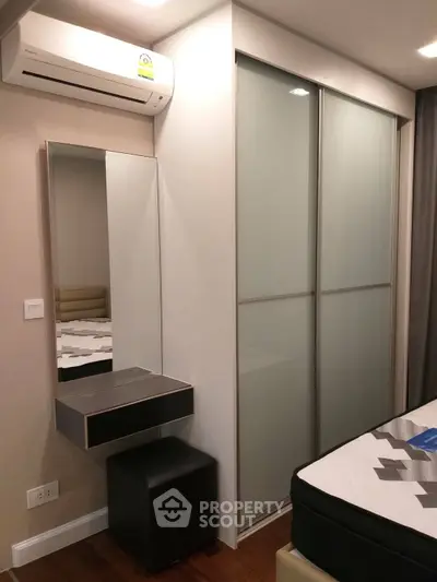 Modern bedroom with sleek closet and air conditioning unit