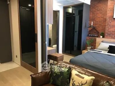 Stylish modern bedroom with exposed brick wall and cozy decor