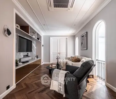 Elegant living room with modern decor and herringbone wood flooring