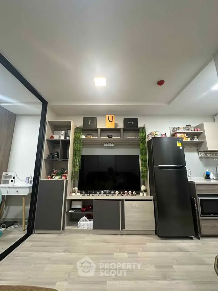 Modern living room with sleek entertainment center and kitchen appliances