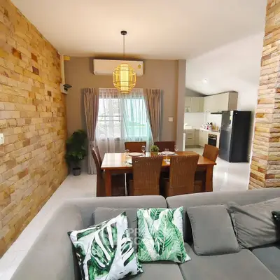 Charming open-plan living and dining area with modern kitchen and stylish decor.