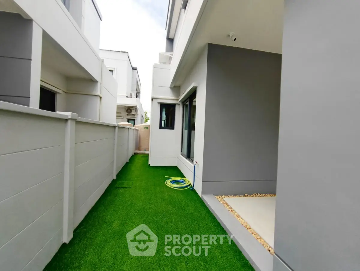 Modern townhouse exterior with artificial grass and sleek design