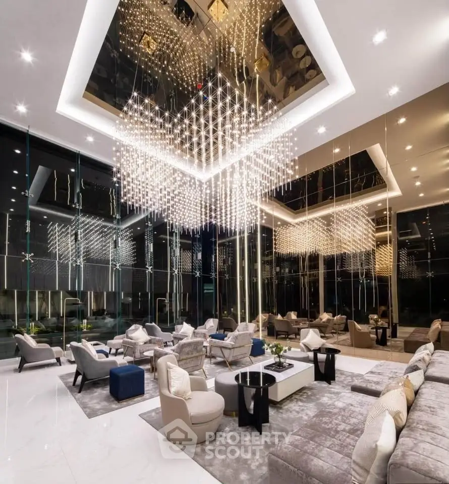 Luxurious modern living room with stunning chandelier and elegant seating area.