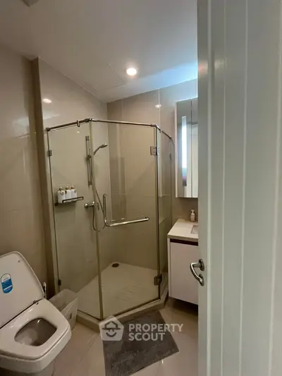 Modern bathroom with glass shower enclosure and sleek fixtures