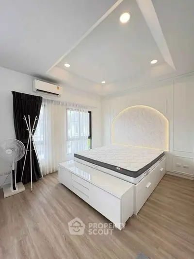 Modern bedroom with stylish lighting and sleek furniture design.