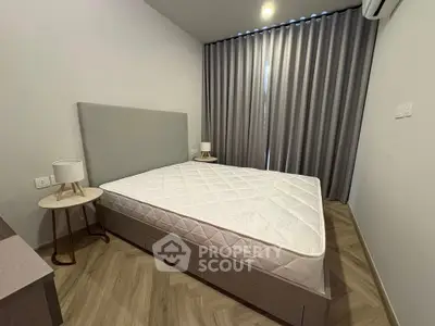Modern bedroom with minimalist design featuring a large bed and stylish side tables.