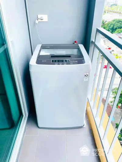 Modern balcony with washing machine and city view