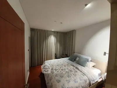 Cozy bedroom with elegant decor and soft lighting, featuring a comfortable bed and stylish curtains.