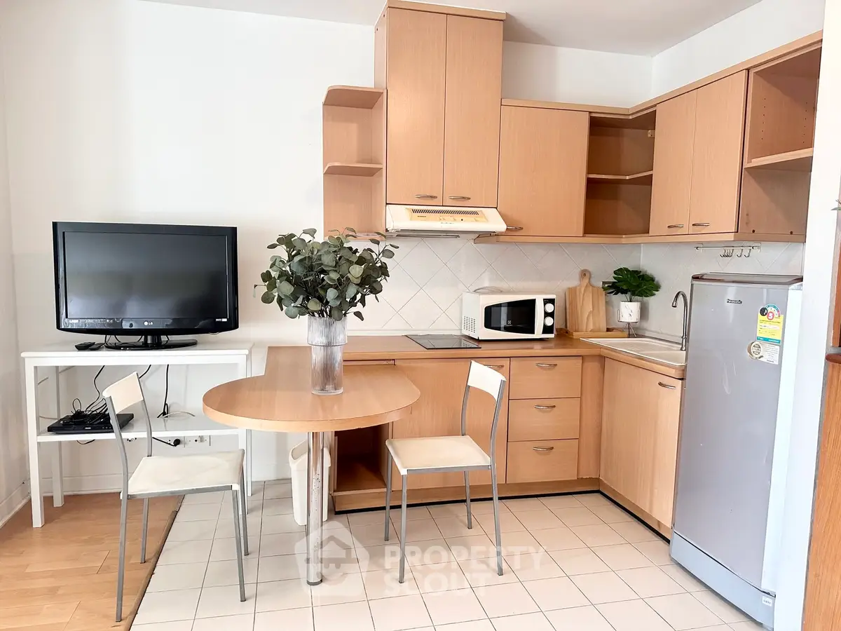 Charming kitchen with wooden cabinets, modern appliances, and cozy dining area.