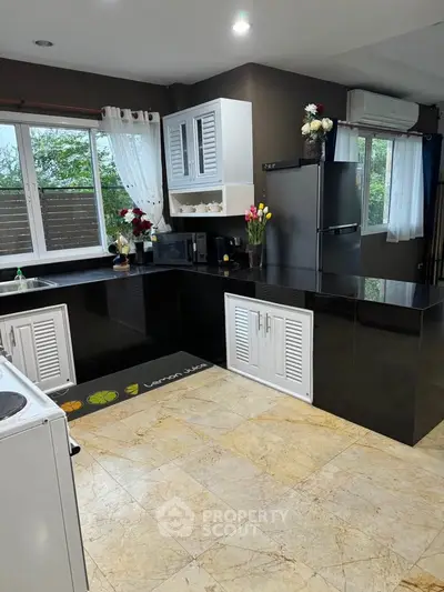 Modern kitchen with sleek black countertops and stainless steel appliances