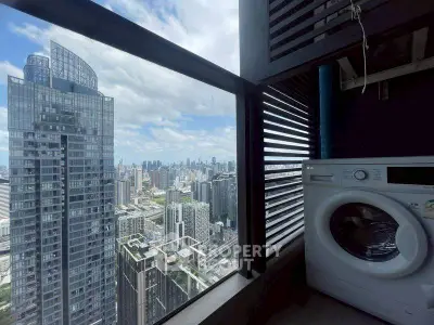 Stunning high-rise view with modern washing machine in urban apartment balcony.