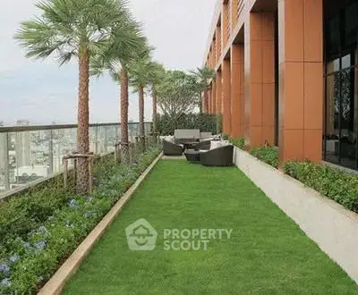 Luxurious rooftop garden with seating area and stunning city views.
