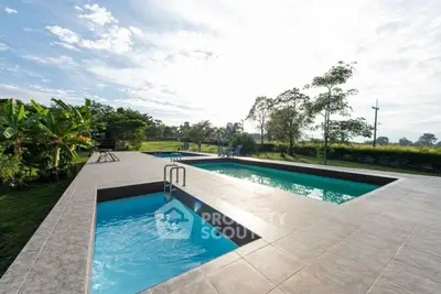 Luxurious outdoor pool with scenic views and lush greenery, perfect for relaxation and entertainment.