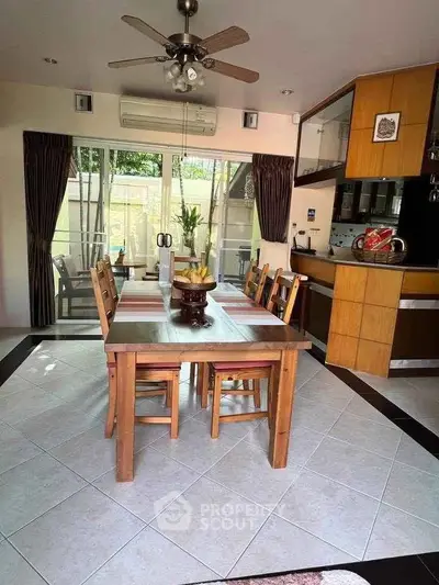 Charming dining area with wooden table, modern kitchen, and garden view, perfect for family gatherings.