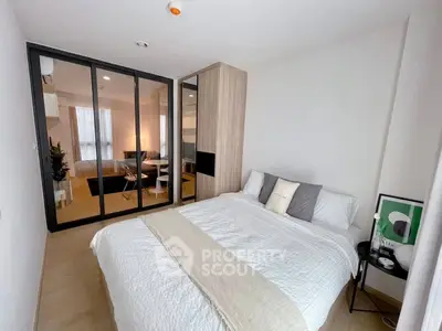 Modern bedroom with mirrored closet and cozy decor