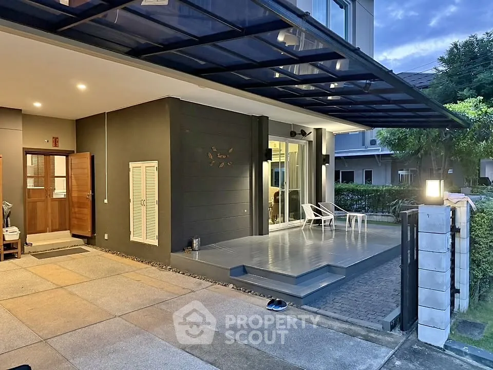 Modern home exterior with covered patio and stylish lighting