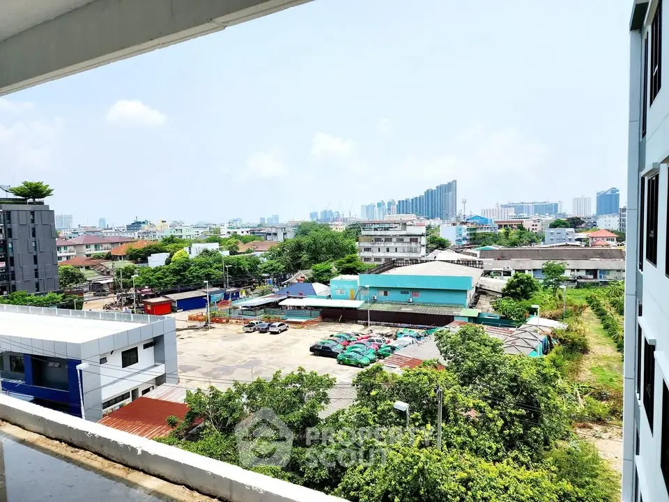 Stunning cityscape view from a modern apartment balcony, showcasing urban skyline and lush greenery.