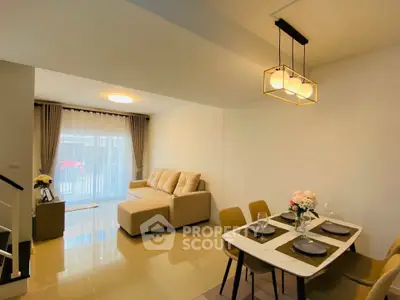 Modern living room with cozy sofa and elegant dining area in a stylish open layout.