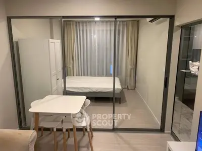 Modern studio apartment with glass partition and cozy dining area