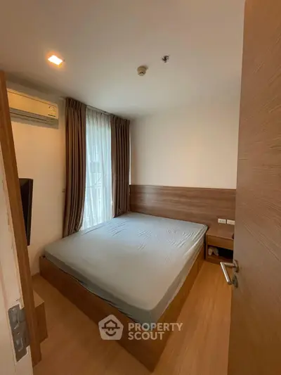 Cozy bedroom with modern design and natural light in a stylish apartment.