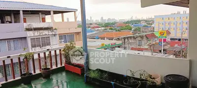 Charming urban balcony with cityscape view, perfect for relaxing and enjoying the skyline.