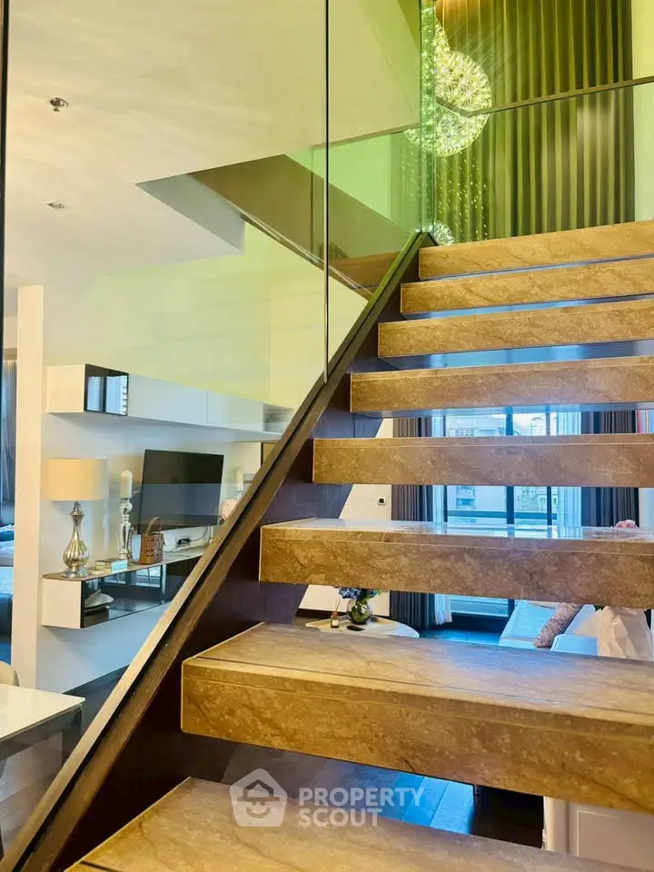 Luxurious modern staircase with glass railing in elegant living space