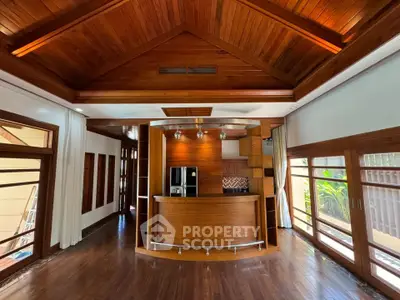Stunning wooden interior with vaulted ceiling and modern bar area, perfect for entertaining.