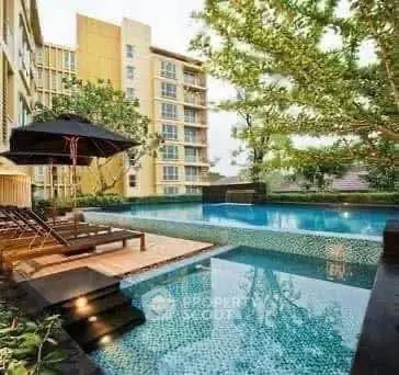 Luxurious apartment complex with a stunning outdoor pool and lush greenery, perfect for relaxation and leisure.