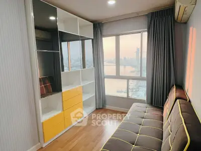 Modern living room with city view, stylish shelving, and cozy seating area.
