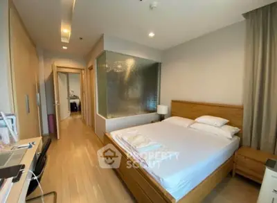 Spacious modern bedroom with wooden flooring and stylish decor