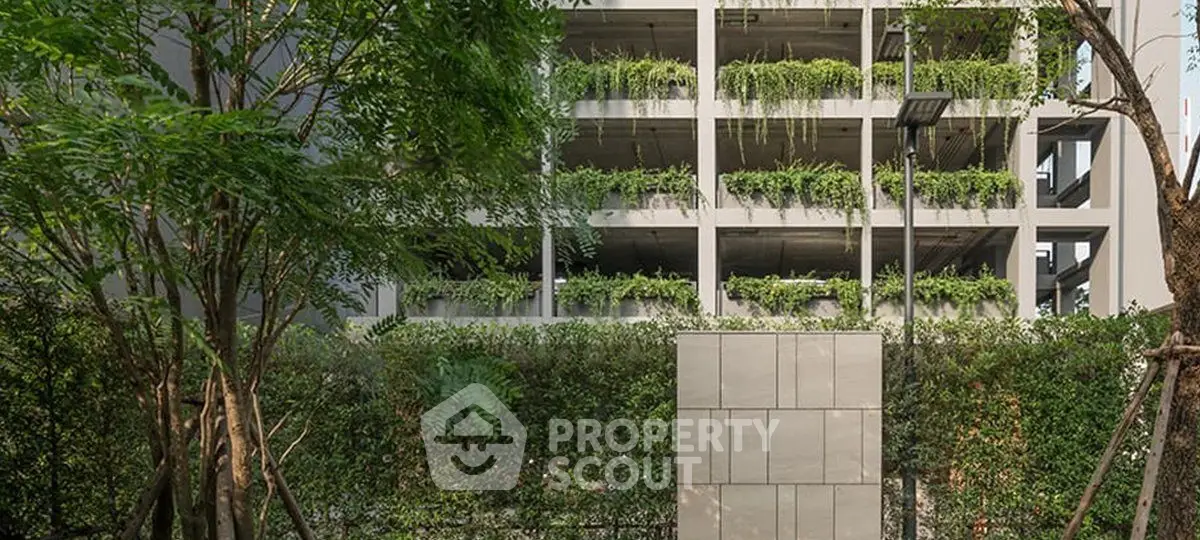 Modern building exterior with lush greenery and vertical garden design.