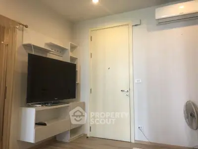 Modern living room with wall-mounted TV and air conditioning unit