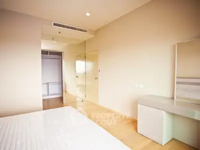 Spacious modern bedroom with minimalist design and ample natural light