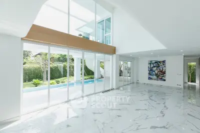 Luxurious modern living room with marble floors and pool view