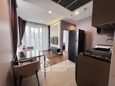 Modern open-layout living room with sleek kitchen and dining area, featuring large windows and stylish decor.