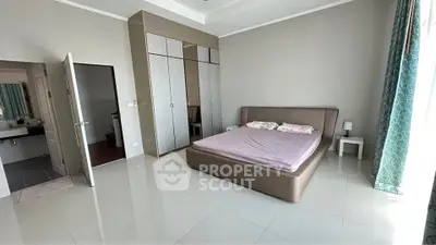 Spacious bedroom with modern design and large wardrobe