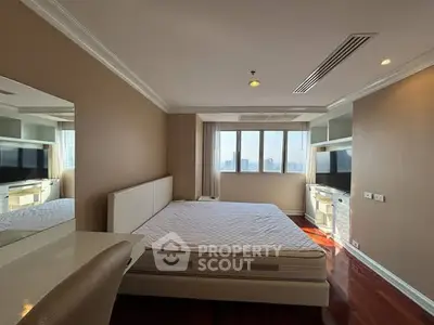 Spacious bedroom with city view and modern furnishings