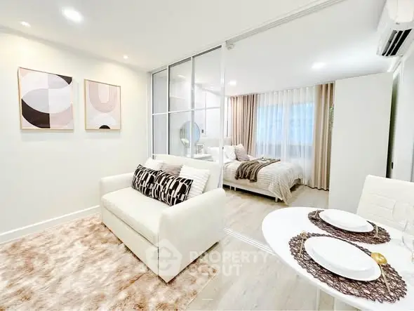 Modern open-plan living room with cozy bedroom and stylish decor