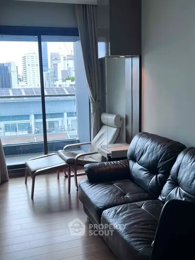 Modern living room with leather sofa and city view through large window.