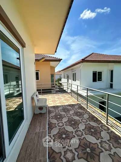 Spacious balcony with stylish tiles and scenic view in modern residential building.