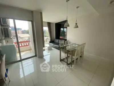 Bright modern living room with balcony and dining area in urban apartment