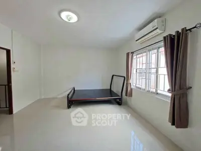 Spacious unfurnished bedroom with air conditioning and natural light