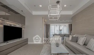 Modern living room with elegant decor and spacious layout, featuring a sleek TV unit and stylish lighting.