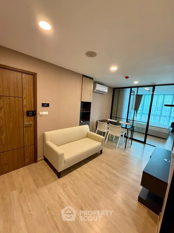 Modern living room with wooden flooring and stylish furniture in a contemporary apartment.