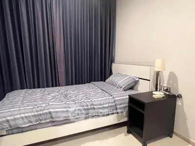 Cozy bedroom with modern decor and stylish bedding in a serene setting.