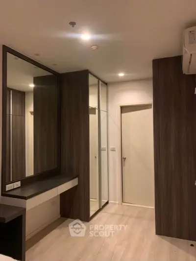 Modern bedroom with sleek wooden accents and large mirror